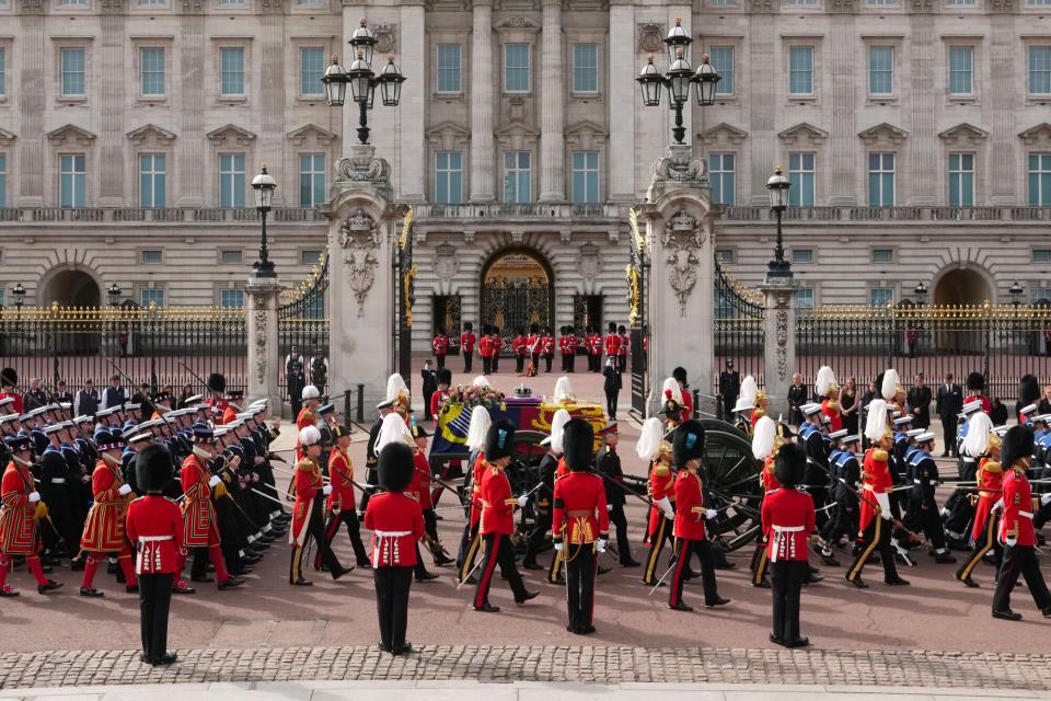 The coffin of Queen Elizabeth II with the Imperial State Crown resting on top, borne on the State Gun Carriage of the Royal Navy followed by members of the royal family proceeds past Buckingham Palace on September 19, 2022 in London, England. Elizabeth Alexandra Mary Windsor was born in Bruton Street, Mayfair, London on 21 April 1926. She married Prince Philip in 1947 and ascended the throne of the United Kingdom and Commonwealth on 6 February 1952 after the death of her Father, King George VI. Queen Elizabeth II died at Balmoral Castle in Scotland on September 8, 2022, and is succeeded by her eldest son, King Charles III.