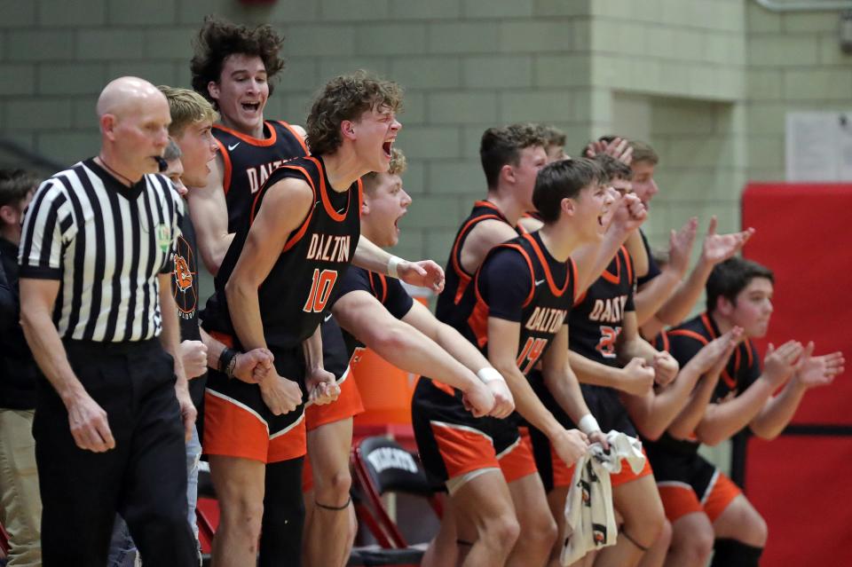 The Dalton bench erupts as the Bulldogs tie the score in the second half of a Division IV district semifinal basketball game at Struthers Fieldhouse, Monday, March 4, 2024, in Struthers, Ohio.