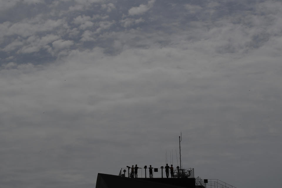 Visitors look at the northern side at the Imjingak Pavilion in Paju, South Korea, Sunday, June 14, 2020. South Korea on Sunday convened an emergency security meeting and urged North Korea to uphold reconciliation agreements, hours after the North threatened to demolish a liaison office and take military action against its rival. (AP Photo/Lee Jin-man)