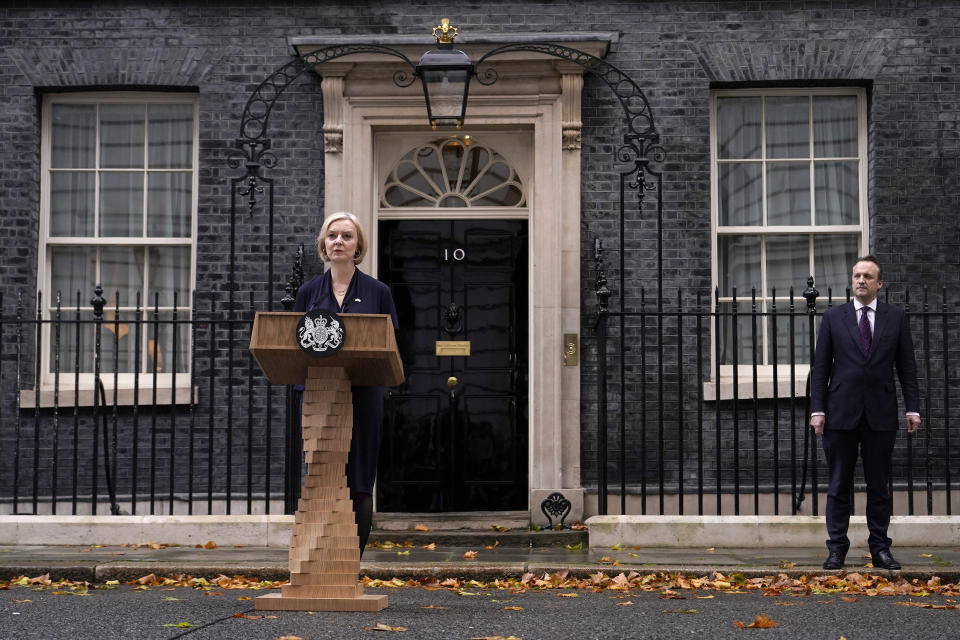 Britain's Prime Minister Liz Truss and husband Hugh O'Leary leave 10 Downing Street to address the media in London, Thursday, Oct. 20, 2022. British Prime Minister Liz Truss resigned Thursday — bowing to the inevitable after a tumultuous six-week term in which her policies triggered turmoil in financial markets and a rebellion in her party obliterated her authority.  (AP Photo/Alberto Pezzali)