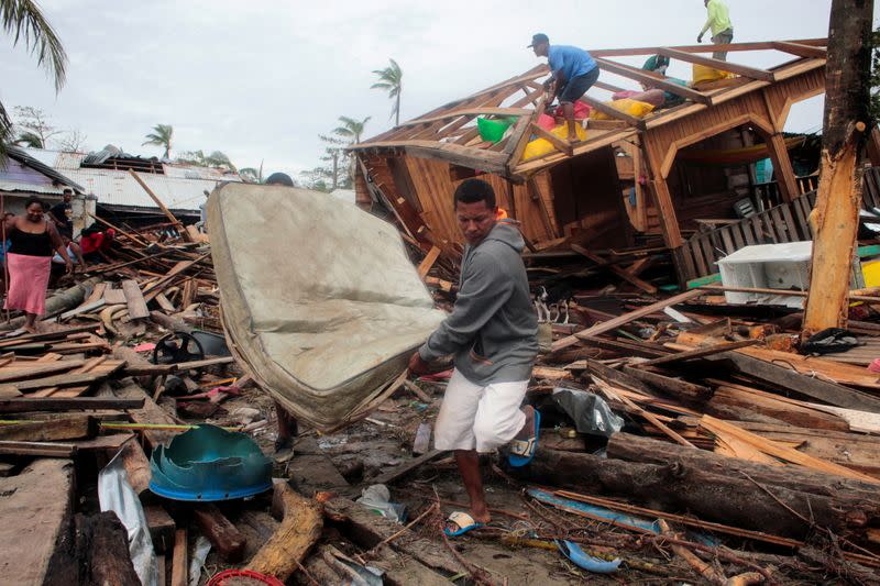 Residents recover a mattress from the debris of their house damaged by the passing of Hurricane Iota, in Puerto Cabezas