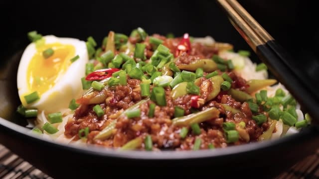 Garnished spicy bean paste noodles with onsen egg