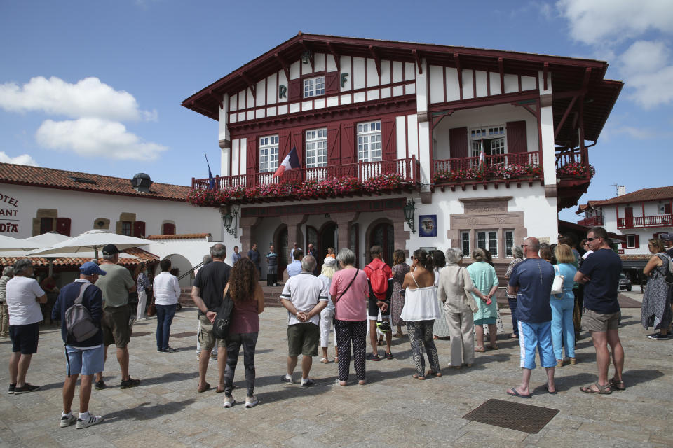 Residents listen to a speech during a gathering in a show of solidarity with the mayor of the Paris suburb of L'Hay-les-Roses after a burning car struck his home, Monday July 3, 2023 in Bidart, southwestern France. Unrest across France sparked by the police shooting of a 17-year-old appeared to slow on its sixth night, but still public buildings, cars and municipal trash cans were targeted nationwide by fires and vandalism overnight into Monday. (AP Photo/Bob Edme)