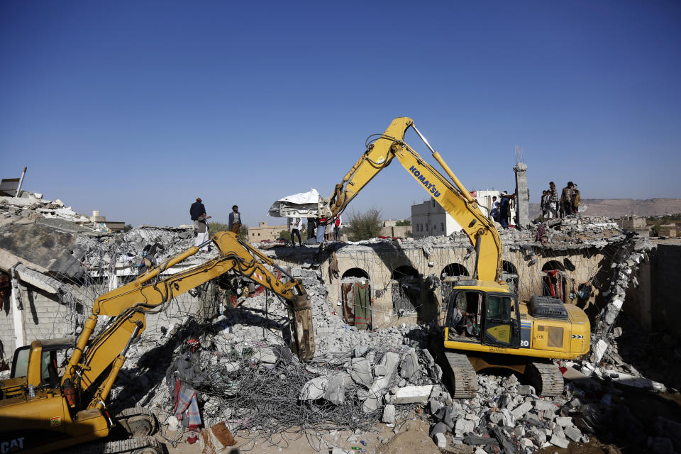 People search the rubble of a prison facility hit by a Saudi-led coalition airstrike that killed at least 87 people, in a stronghold of Houthi rebels on the border with Saudi Arabia, in the northern Saada province of Yemen, Saturday, Jan. 22, 2022. Internet access remained largely down on Sunday after another Saudi-led coalition airstrike hit a telecommunications center Friday at the Red Sea port city of Hodeida. (AP Photo/Hani Mohammed)