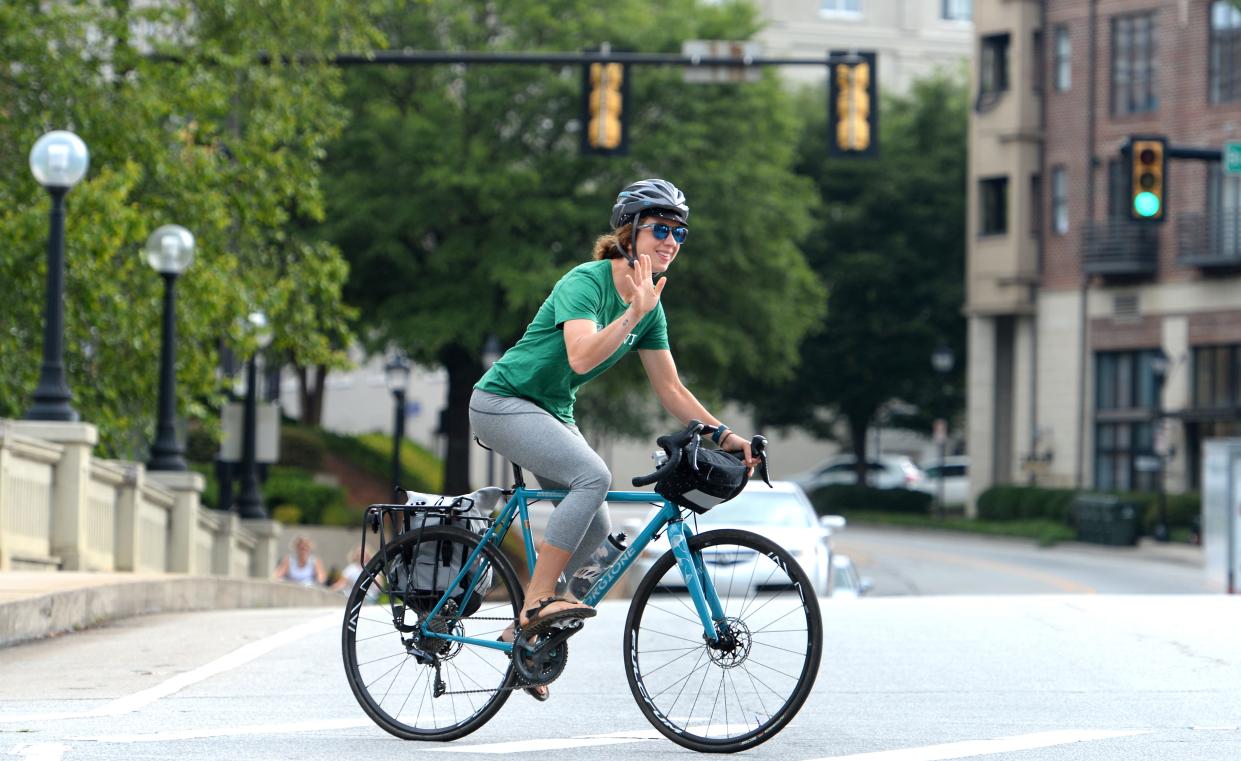 Mary McGowan, a resident of Sans Souci, SC, has opted out of having a car and uses her bike to transport around the area. McGowan makes sure the road is clear before changing lanes.