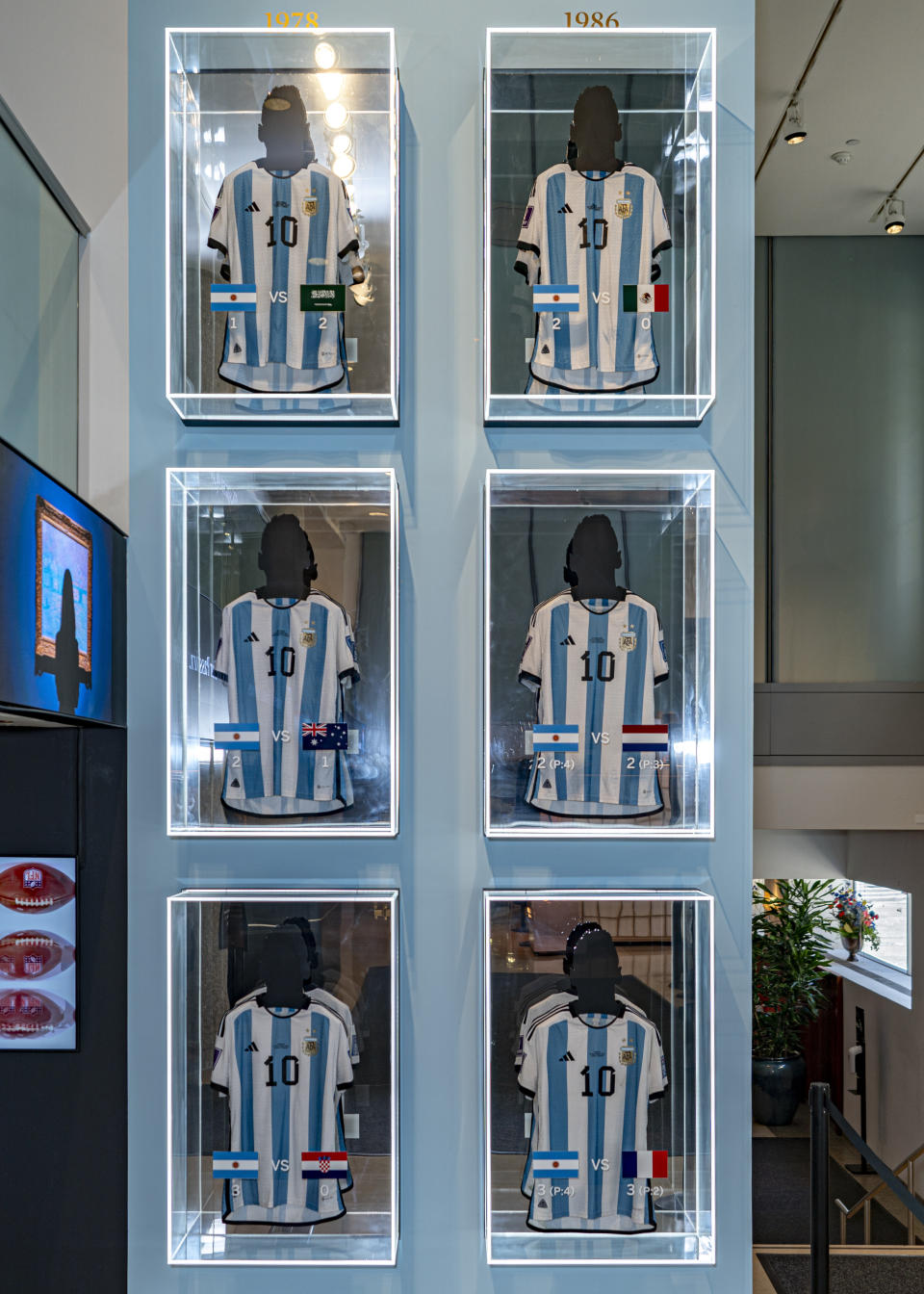 FILE - A collection of six shirts, worn by footballer Lionel Messi at the 2022 FIFA World Cup, on display at Sotheby's, Nov. 30, 2023, in New York. Six jerseys worn by Messi during Argentina’s winning run at last year’s World Cup have sold for $7.8 million. The auction house Sotheby's final price for the shirts is the highest price for an item of sports memorabilia this year, Sotheby’s said, Thursday, Dec. 14, 2023. (AP Photo/Peter K. Afriyie, file)