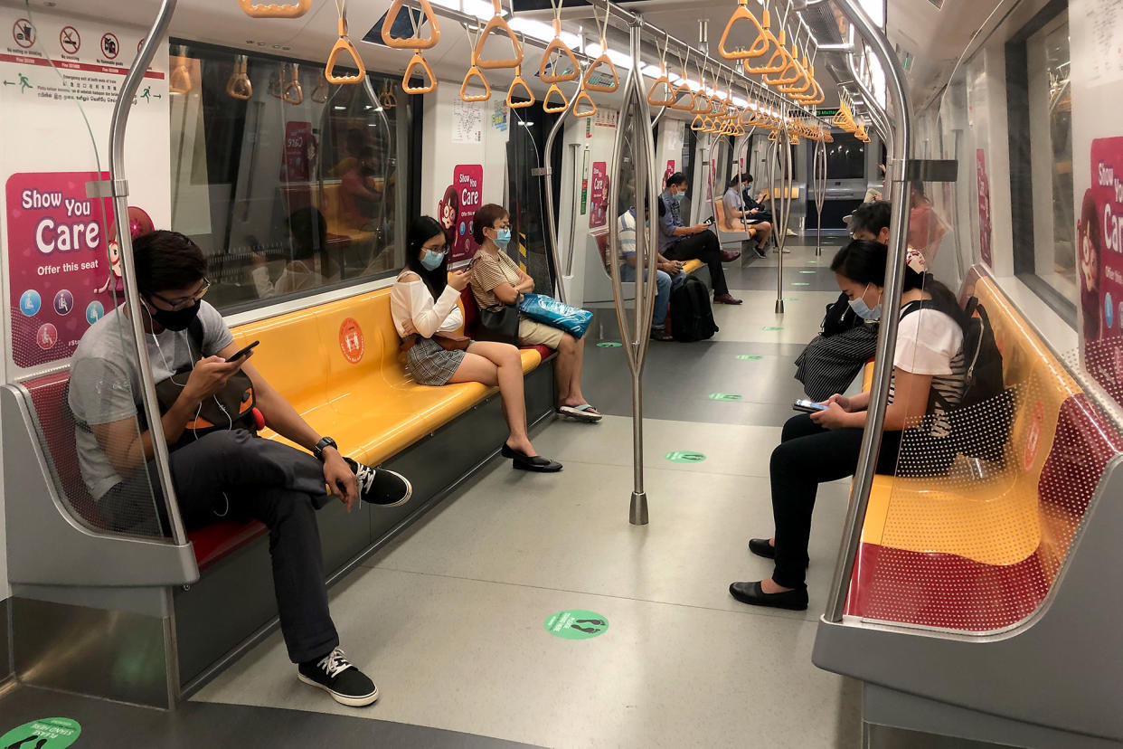 Commuters in face masks seen aboard a Downtown Line MRT train. (PHOTO: Dhany Osman / Yahoo News Singapore)