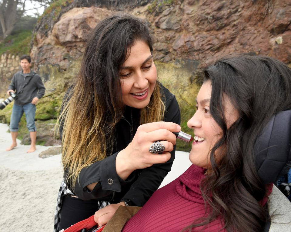 Maribel Vargas applies lipstick for her daughter Karizma at Carmel State Beach as they get ready to take graduation photos April 19, 2019. 