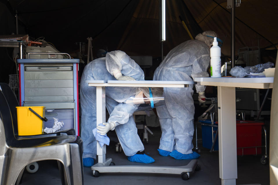 Medical staff cleans a tent where Covid-19 patients are being treated at the Tshwane District Hospital in Pretoria, South Africa, Friday July 10, 2020. Health Minister Zweli Mkhize this week said South Africa could run out of available hospital beds within the month. "The storm that we have consistently warned South Africans about is now arriving," he told lawmakers. The African continent overall has over 523,000 confirmed virus cases after passing the half-million milestone on Wednesday. But shortages in testing materials mean the true number is unknown.(AP Photo/Jerome Delay)