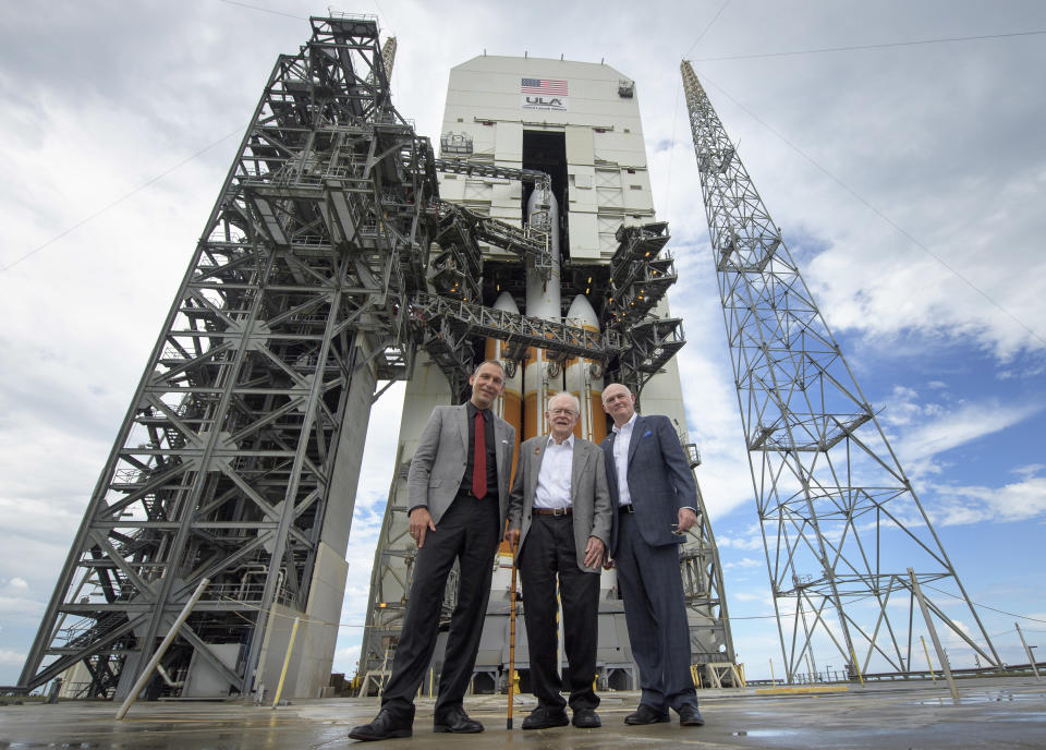 CORRECTS SPELLING TO TORY, NOT TONY - In this photo provided by NASA, astrophysicist Eugene Parker, center, stands with NASA Associate Administrator for the Science Mission Directorate Thomas Zurbuchen, left, and United Launch Alliance President and Chief Executive Officer Tory Bruno in front of the ULA Delta IV Heavy rocket with NASA's Parker Solar Probe onboard, Friday, Aug. 10, 2018 at Cape Canaveral Air Force Station, Fla. Humanity's first-ever mission into a part of the Sun's atmosphere called the corona, is scheduled to launch early Saturday. (Bill Ingalls/NASA via AP)