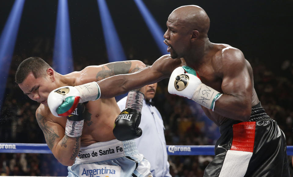 Floyd Mayweather Jr., right, connects with a right to the head of Marcos Maidana, from Argentina, in their WBC-WBA welterweight title boxing fight Saturday, May 3, 2014, in Las Vegas. (AP Photo/Eric Jamison)