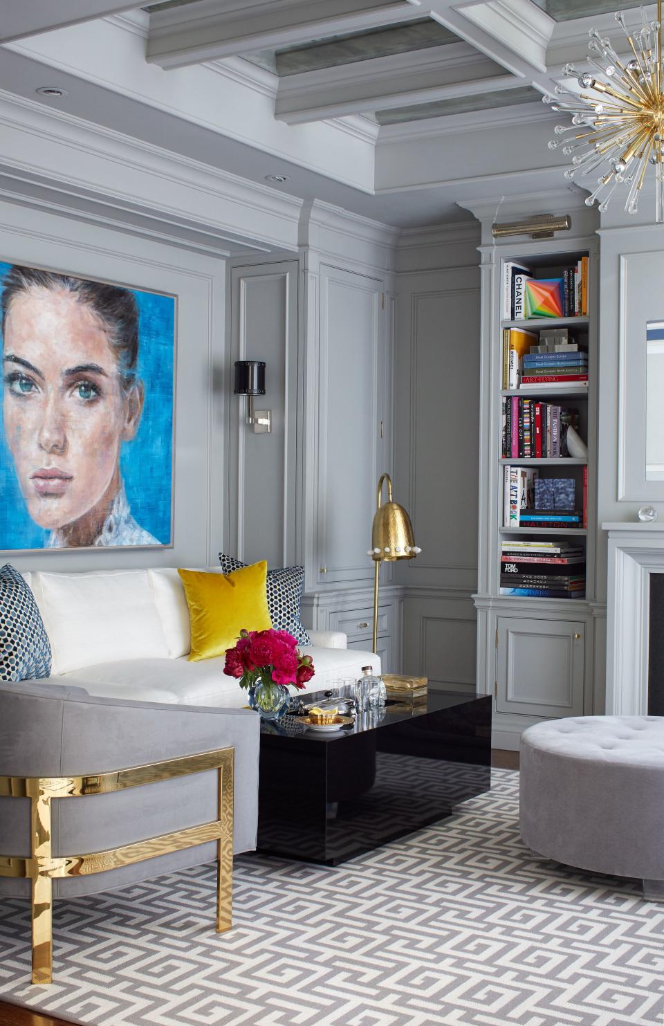 Hepfer installed antique mirrors inside the ceiling coffers to bring depth and dimension to the neutral space, while the gray-and-white Greek key rug offers a touch of pattern. A Harding Meyer portrait hangs above the sofa.