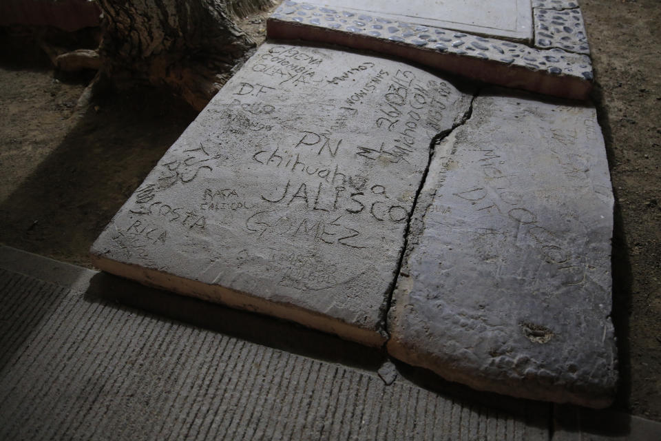 People's names and locations are carved into a cement walkway at the entrance to a prisoner bungalow at the Morelos detention center during a media tour of the former Islas Marias penal colony located off Mexico's Pacific coast, before dawn Sunday, March 17, 2019. It's unclear if Islas Marias ever really worked as a penal colony: The remote Mexican archipelago is battered regularly by hurricanes, and its ramshackle, often century-old installations are sprinkled with the ruins of failed "productive" projects that once aimed to make the prison population self-sustaining. (AP Photo/Rebecca Blackwell)