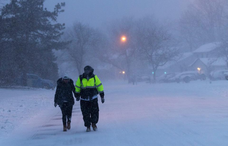 A couple takes a walk in the snow along Barnegat Blvd in Barnegat Township as rises somewhere above the snowstorm. 