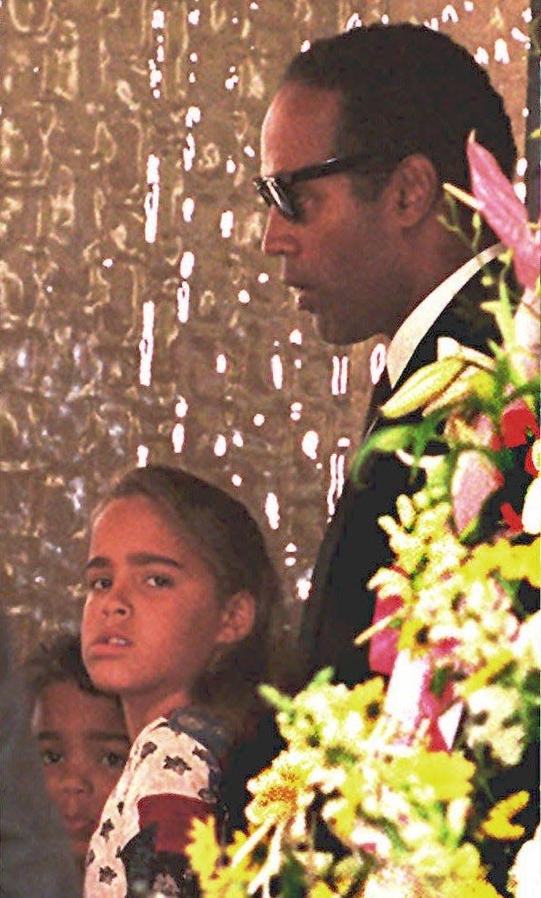 O.J. Simpson attends the funeral of his ex-wife, Nicole Brown Simpson, with their children Sydney and Justin Simpson on June 16, 1994.