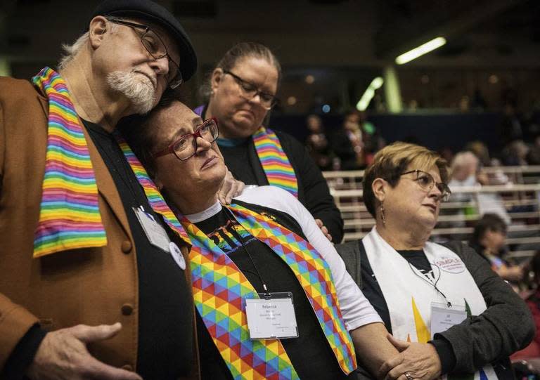 In this Feb. 26, 2019, file photo, Ed Rowe, left, Rebecca Wilson, Robin Hager and Jill Zundel, react to the defeat of a proposal that would allow LGBTQ clergy and same-sex marriage within the United Methodist Church at the denomination’s 2019 Special Session of the General Conference in St. Louis.