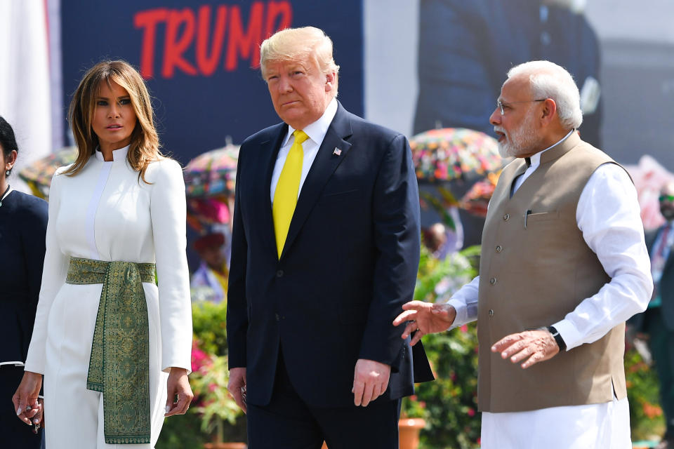 India's Prime Minister Narendra Modi (R) speaks with US President Donald Trump (C) and First Lady Melania Trump (L) upon their arrival at Sardar Vallabhbhai Patel International Airport in Ahmedabad on February 24, 2020. (Photo by Mandel NGAN / AFP) (Photo by MANDEL NGAN/AFP via Getty Images)