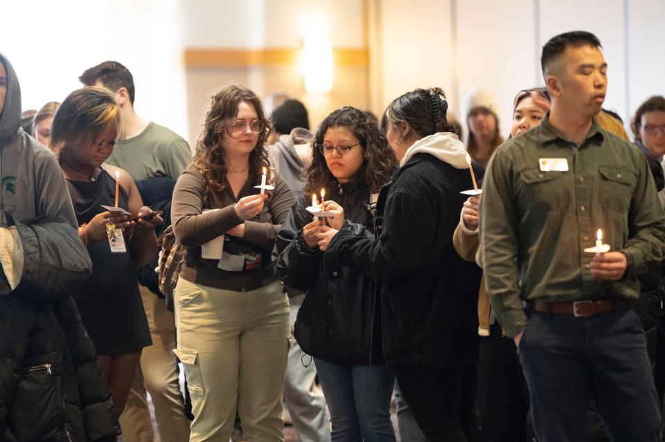 WMU students and community members gather in the Bernhard Center for a candlelight vigil honoring Michigan State University mass shooting victims at Western Michigan University in Kalamazoo on Wednesday, Feb. 15, 2023.