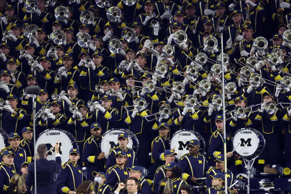 The Michigan Wolverines marching band performs before the national championship game.