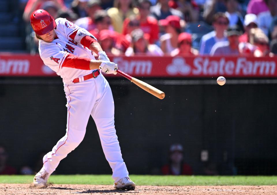 Los Angeles Angels third baseman David MacKinnon (39) breaks his bat on a RBI single in the seventh inning against the Seattle Mariners at Angel Stadium on June 26, 2022.