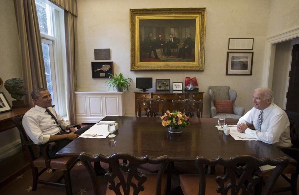 President Barack Obama and Vice President Joe Biden talk during a photo-op as they meet for lunch in the Private Dining Room of the White House in Washington, Wednesday, Jan. 8, 2014. (AP Photo/Carolyn Kaster)