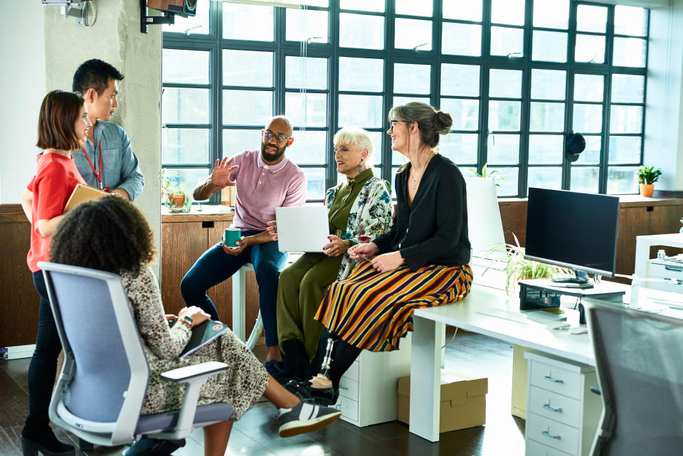 A group of people having a discussion in an office