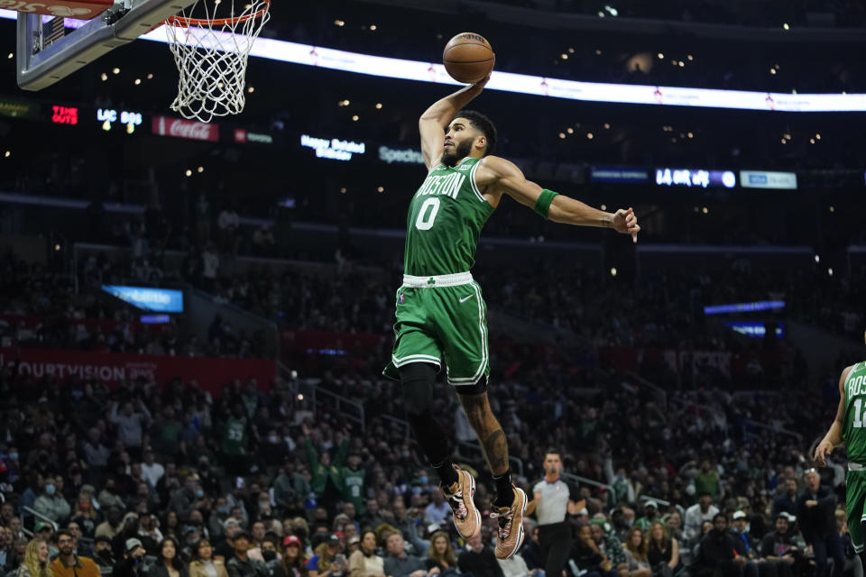 Boston Celtics forward Jayson Tatum (0) dunks the ball during the second half of an NBA basketball game against the Los Angeles Clippers in Los Angeles, Wednesday, Dec. 8, 2021. (AP Photo/Ashley Landis)