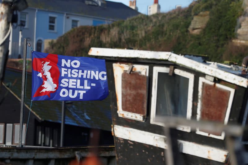 A flag with a slogan supporting the UK fishing industry is seen on the beach in Hastings