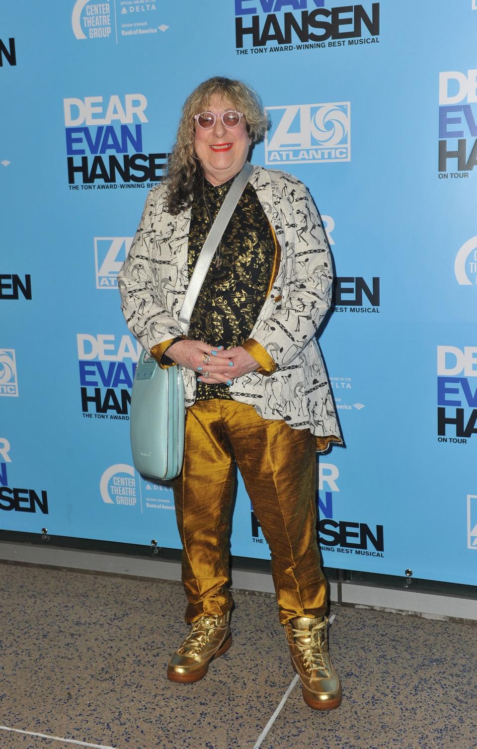 Allee Willis poses at Dear Evan Hansen premiere wearing a sequined top and gold pants