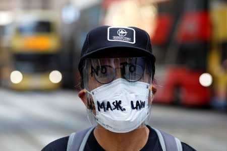 An anti-government protester wearing a mask attends a lunch time protest, after local media reported on an expected ban on face masks under emergency law, at Central, in Hong Kong