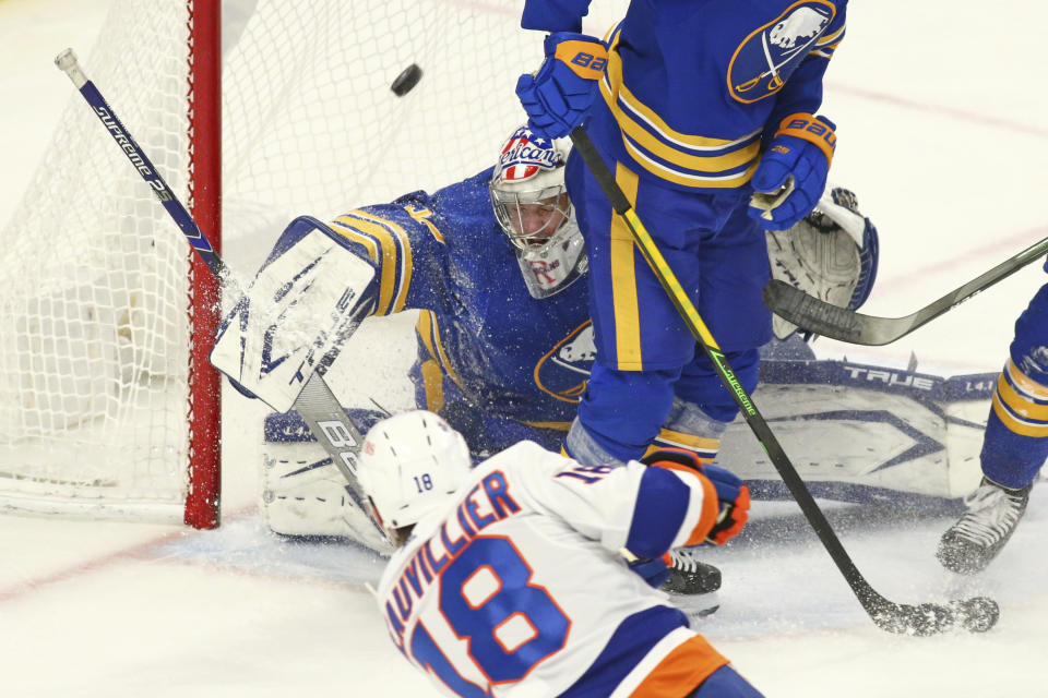 Buffalo Sabres goalie Michael Houser (32) stops New York Islanders forward Anthony Beauvollier (18) during the first period of an NHL hockey game, Monday, May 3, 2021, in Buffalo, N.Y. (AP Photo/Jeffrey T. Barnes)