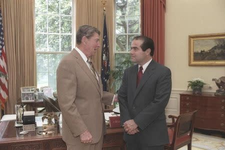 U.S. President Ronald Reagan speaks with Supreme Court Justice nominee Antonin Scalia (R) in the White House Oval Office in Washington, DC in a July 7, 1986 file photo courtesy of the Ronald Reagan Library. REUTERS/Bill Fitz-Patrick/White House/Courtesy Ronald Reagan Library/Handout via Reuters