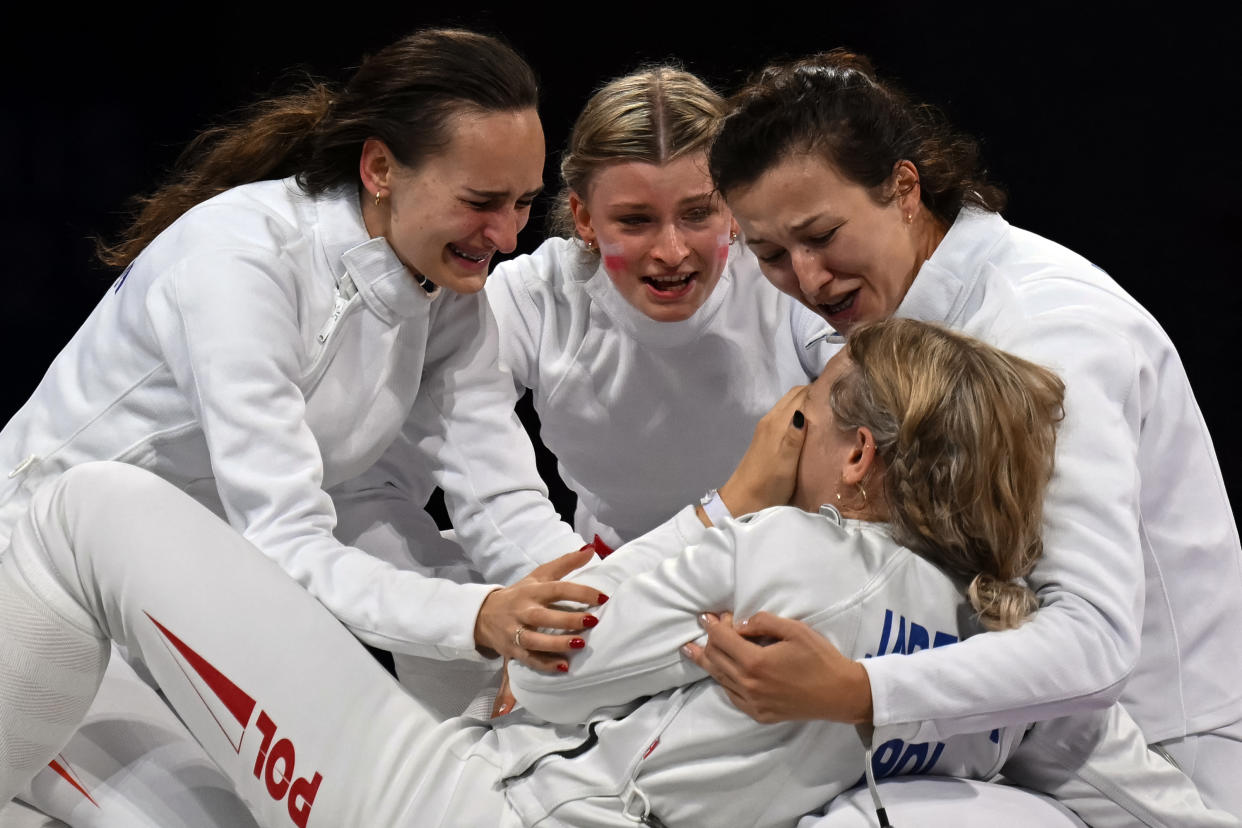 Poland's Aleksandra Jarecka and teammates celebrate after winning against Team China in the women's epee team bronze medal bout during the Paris 2024 Olympic Games at the Grand Palais in Paris, on July 30, 2024. (Photo by Fabrice COFFRINI / AFP)