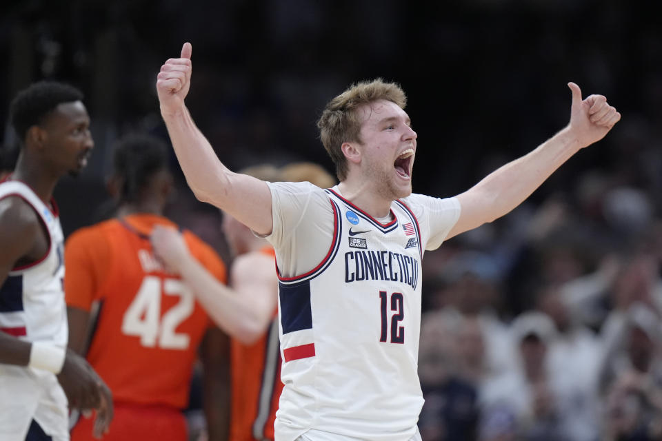 UConn guard Cam Spencer (12) celebrates during the second half of the Elite 8 college basketball game against Illinois in the men's NCAA Tournament, Saturday, March 30, 2024, in Boston. (AP Photo/Steven Senne)