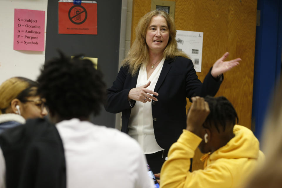 In this Wednesday, Feb. 5, 2020 photo, India Meissel, a history teacher and past president of the National Council on Social Studies, gestures during her class at Lakewood High School in Suffolk, Va. Fairfax County Public Schools in Virginia is defending a recent partnership with the nonprofit educational group Izzit.org, in producing a video presentation from a conservative federal judge on the Constitution. Izzit.org is facing criticism that its materials are ideologically skewed. Meissel said some teachers might use Izzit material and see a need to balance it out with a different perspective. “A good teacher presents both sides,” she said. (AP Photo/Steve Helber)