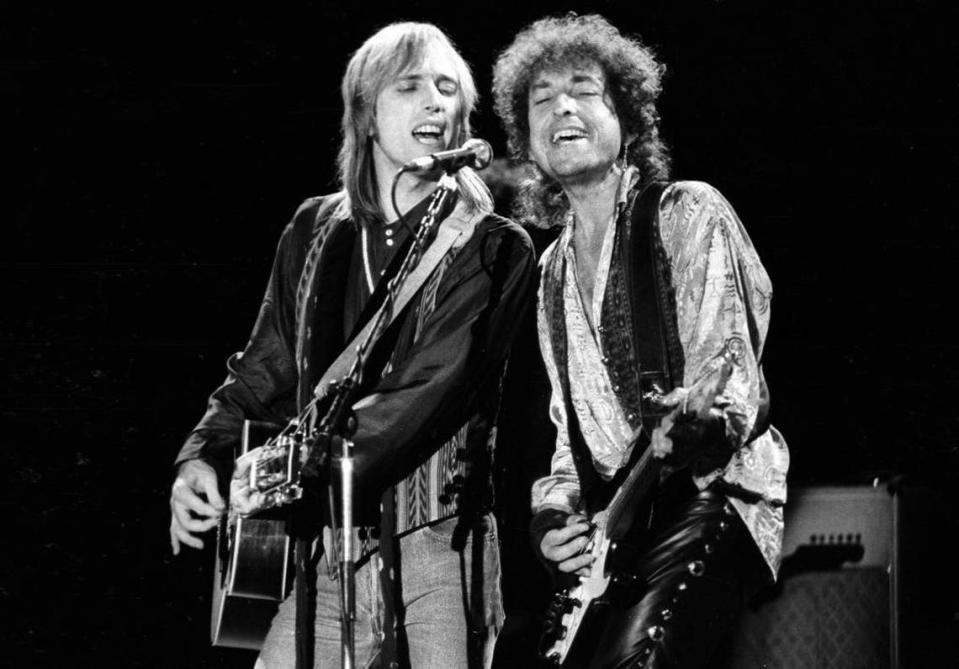 Tom Petty, left, and Bob Dylan sing harmony during the last night of the True Confessions tour at the Mid-State Fair in Paso Robles in 1986.