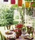 <p>For a pulled-together look, pair inexpensive paper lanterns with backyard flowers like zinnias in pinks, reds, oranges and yellows. Save some stems for a sweet touch at each place setting.<br></p>