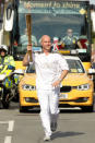 British former swimmer Adrian Moorhouse carries the Olympic Flame on the Torch Relay leg between Felixstowe and Ipswich.