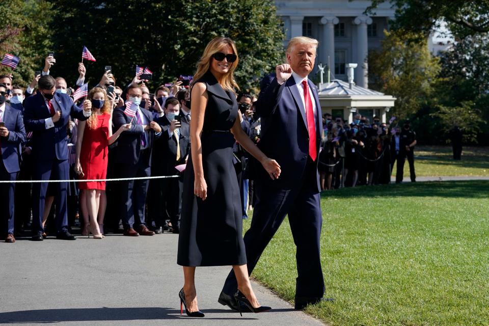 President Donald Trump and first lady Melania Trump walk to board Marine One on the South Lawn of the White House on Thursday. Trump is headed to Nashville, Tennessee, for a debate with Joe Biden.