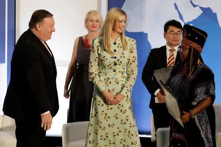 U.S. Secretary of State Mike Pompeo and White House senior advisor Ivanka Trump greet Francisca Awah Mbuli, survivor of human trafficking from Cameroon, during an event to unveil the 2018 Trafficking in Persons (TIP) Report at the State Department in Washington, U.S., June 28, 2018. REUTERS/Yuri Gripas