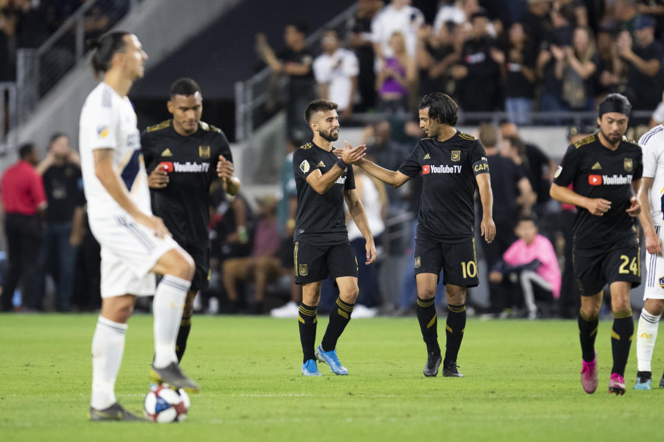 LAFC celebrates one of the goals from Carlos Vela (10) on Thursday as LA Galaxy forward Zlatan Ibrahimovic looks on. (Kyusung Gong/Getty)