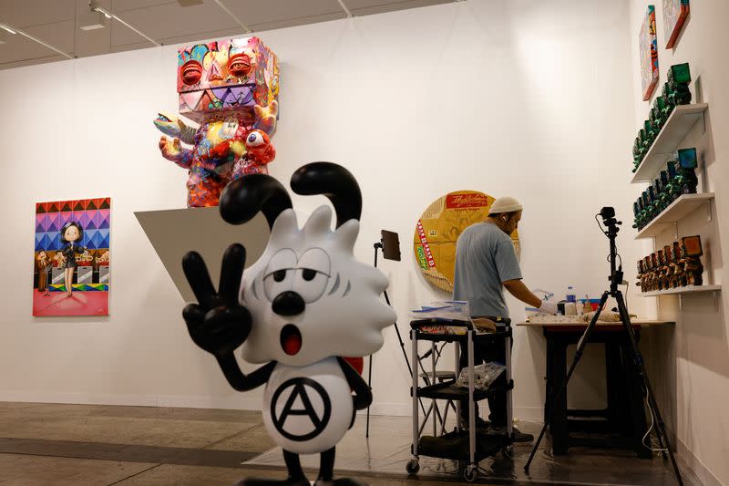 An artist works on his work at Art Basel in Hong Kong