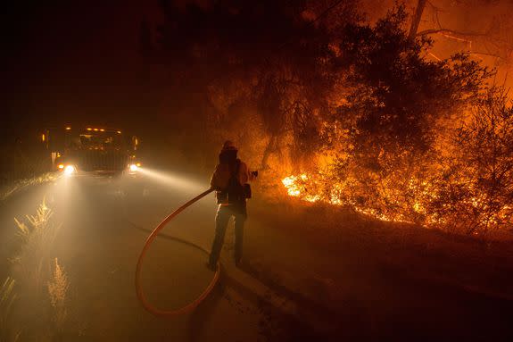 A firefighter douses flames near Loma Prieta, California, Sept. 28, 2016.