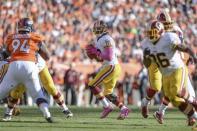 Washington Redskins quarterback Robert Griffin III (10) drops back to pass in the second quarter against the Denver Broncos at Sports Authority Field at Mile High. Mandatory Credit: Ron Chenoy-USA TODAY Sports