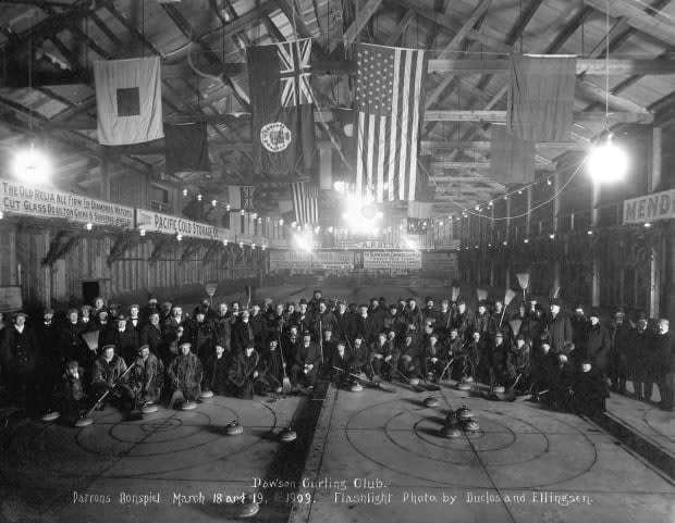 Dozens of members of the Dawson City Curling Club pose for a photo in March 1909.