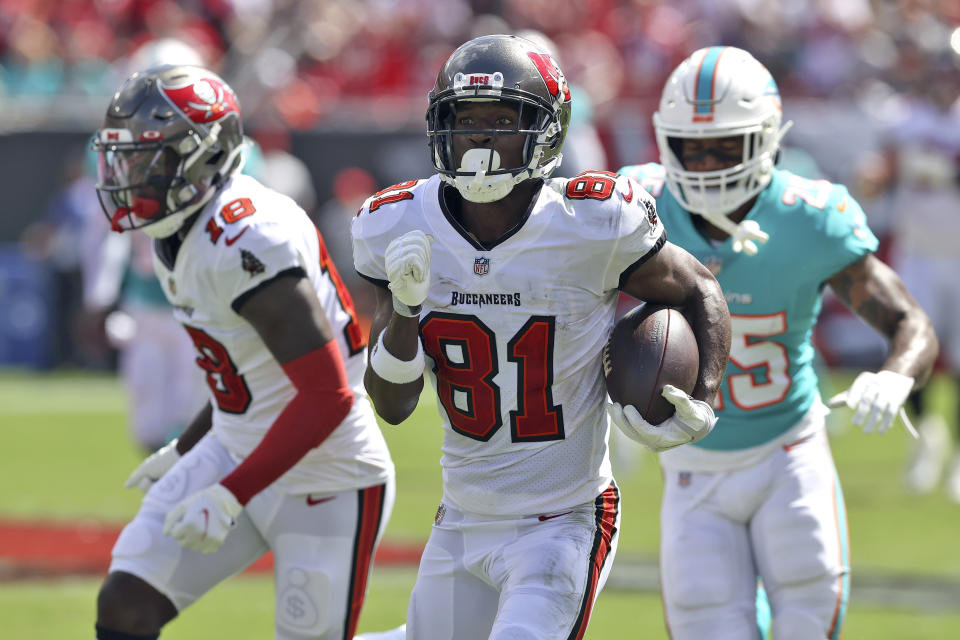 Tampa Bay Buccaneers wide receiver Antonio Brown (81) heads for the endzone to score on a 62-yard touchdown reception during the first half of an NFL football game against the Miami Dolphins Sunday, Oct. 10, 2021, in Tampa, Fla. (AP Photo/Mark LoMoglio)