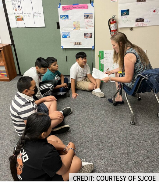 Teacher Colleen Guidi works with students in the summer school class for English learners in Lodi Unified.