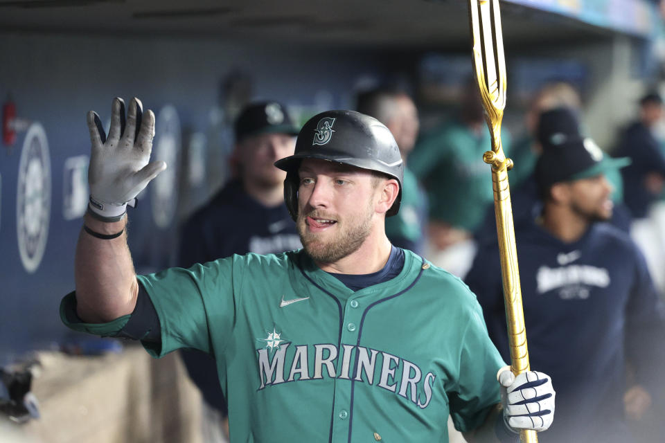 Seattle Mariners' Luke Raley celebrates in the dugout after hitting a home run off Los Angeles Angels pitcher Carson Fulmer during the sixth inning of a baseball game, Saturday, June 1, 2024, in Seattle. (AP Photo/Jason Redmond)