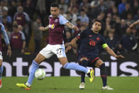 Aston Villa's Morgan Rogers, left, challenges for the ball with Lille's Benjamin Andre during the Europa Conference League quarter final first leg soccer match between Aston Villa and Lille at Villa Park in Birmingham, England, Thursday, April 11, 2024. (AP Photo/Rui Vieira)