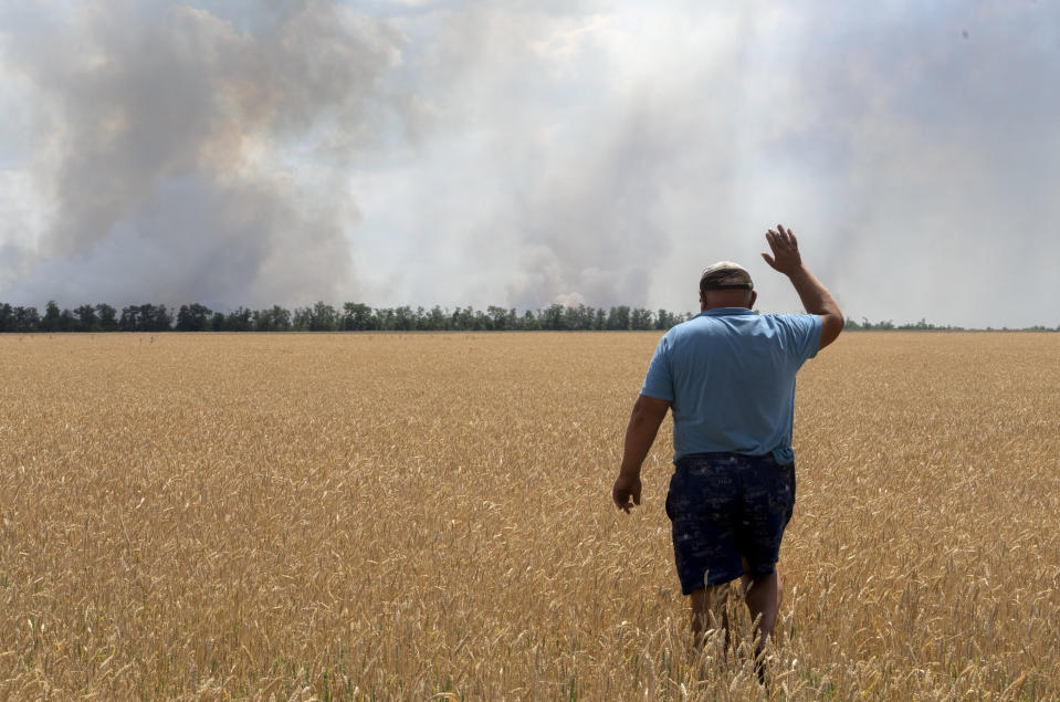 FILE - A farmer reacts as he looks at his burning field caused by the fighting at the front line in the Dnipropetrovsk region, Ukraine, Monday, July 4, 2022. Military officials from Russia and Ukraine are set to hold a meeting in Istanbul to discuss a United Nations plan to export blocked Ukrainian grain to world markets through the Black Sea. Russia’s invasion and war disrupted production and halted shipments of Ukraine, one of the world’s largest exporters of wheat, corn and sunflower oil. (AP Photo/Efrem Lukatsky)